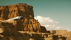 Gif of car driving off cliff with desert background on a post about perimenopause cravings and emotional eating
